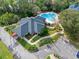 Overhead view of community pool with winding walkways and ample parking, surrounded by trees at 1 Crooked Bridge Way, Ormond Beach, FL 32174
