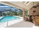 Inviting screened-in pool area with comfortable seating and lush landscaping, creating a relaxing outdoor space at 1 Crooked Bridge Way, Ormond Beach, FL 32174