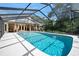 Beautiful enclosed pool with a brick house backdrop, providing a private oasis for year-round enjoyment at 1 Crooked Bridge Way, Ormond Beach, FL 32174