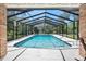 Refreshing screened-in pool with clear blue water and ample space for lounging and relaxing outdoors at 1 Crooked Bridge Way, Ormond Beach, FL 32174