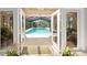 Spacious screened in pool is visible from open french doors at 1 Crooked Bridge Way, Ormond Beach, FL 32174