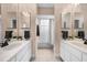 Bathroom featuring dual sinks with granite countertops and tiled floor, with a bath and shower at 11616 Sw 75Th Cir, Ocala, FL 34476