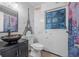 Unique bathroom featuring a vessel sink, toilet, and artistic wall decor at 1333 E Lombardy Dr, Deltona, FL 32725