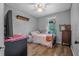 Bedroom featuring laminate flooring, a bed, a window, and a dresser at 1333 E Lombardy Dr, Deltona, FL 32725