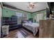 Bedroom featuring gray bedding and laminate flooring at 1333 E Lombardy Dr, Deltona, FL 32725