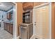 Kitchen area with stainless steel dishwasher and adjacent exterior door entrance at 1333 E Lombardy Dr, Deltona, FL 32725