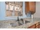 Close-up of a kitchen sink with granite countertops, adding elegance to the culinary space at 1333 E Lombardy Dr, Deltona, FL 32725