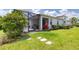 Well-maintained backyard with a screened-in lanai and lush green grass at 206 St Somewhere Dr, Daytona Beach, FL 32124