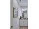 Well-lit bathroom with white cabinets, granite counters and decorative accents at 206 St Somewhere Dr, Daytona Beach, FL 32124