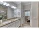 Bathroom features granite countertops, dual sinks, white cabinetry, and glass shower at 206 St Somewhere Dr, Daytona Beach, FL 32124