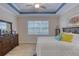 The bedroom boasts neutral walls, ceiling fan, and large windows that fill the space with light at 206 St Somewhere Dr, Daytona Beach, FL 32124