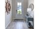 Entryway featuring wood-look floors, console table with decor, and a stylish ship's wheel wall decoration at 206 St Somewhere Dr, Daytona Beach, FL 32124