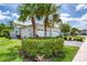 Exterior view of a home with lush green landscaping and a brick driveway under a sunny sky at 206 St Somewhere Dr, Daytona Beach, FL 32124
