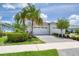 Charming exterior view of a home with a brick driveway, lush landscaping, and a two-car garage under a sunny sky at 206 St Somewhere Dr, Daytona Beach, FL 32124