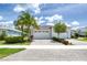 Charming exterior view of a home with a brick driveway, lush landscaping, and a two-car garage under a sunny sky at 206 St Somewhere Dr, Daytona Beach, FL 32124
