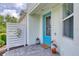 A welcoming front entrance with a blue door, stylish accents, and a well-manicured garden at 206 St Somewhere Dr, Daytona Beach, FL 32124