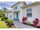 Charming front entrance with a bright blue door, decorative accents, and landscaped walkway at 206 St Somewhere Dr, Daytona Beach, FL 32124
