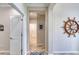 Hallway with neutral walls, wood look tile floors, white doors and white trim at 206 St Somewhere Dr, Daytona Beach, FL 32124
