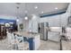 An open-concept kitchen featuring granite counters, stainless steel appliances, and a stylish breakfast bar leading to a dining area at 206 St Somewhere Dr, Daytona Beach, FL 32124