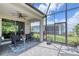 Screened lanai featuring a ceiling fan and outdoor seating at 206 St Somewhere Dr, Daytona Beach, FL 32124