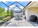Outdoor patio with screened enclosure, dining set, and grill for entertainment at 206 St Somewhere Dr, Daytona Beach, FL 32124