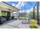 Covered lanai featuring a ceiling fan, outdoor seating, and a screened enclosure at 206 St Somewhere Dr, Daytona Beach, FL 32124