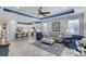 Open-concept living room and kitchen boasts recessed lights, ceiling fan, and coordinating blue accents at 206 St Somewhere Dr, Daytona Beach, FL 32124
