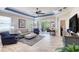 Bright living room features a ceiling fan, recessed lighting, and sliding glass doors to the lanai at 206 St Somewhere Dr, Daytona Beach, FL 32124