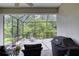 Screened-in lanai featuring patio furniture and outdoor views at 206 St Somewhere Dr, Daytona Beach, FL 32124