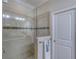 Tiled shower with a glass enclosure, and a marble accent tile and showerhead at 206 St Somewhere Dr, Daytona Beach, FL 32124