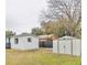 A spacious backyard features both a large building and a metal storage shed, offering ample outdoor space at 279 Selden Ave, Ormond Beach, FL 32174