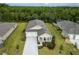 An aerial view of the home showcases the spacious lawn, mature landscaping, and double car garage at 2861 Monaghan Dr, Ormond Beach, FL 32174