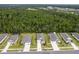Aerial view highlighting a residential community surrounded by mature trees and lush greenery at 2861 Monaghan Dr, Ormond Beach, FL 32174