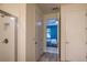 Bright bathroom featuring tiled shower with glass door, neutral walls, and wood look flooring at 2861 Monaghan Dr, Ormond Beach, FL 32174