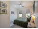 Bedroom with two windows, plush carpet, ceiling fan and a queen bed with decorative pillows at 2861 Monaghan Dr, Ormond Beach, FL 32174