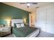 Bedroom features an accent wall, neutral carpet, ceiling fan, and a bed with decorative pillows at 2861 Monaghan Dr, Ormond Beach, FL 32174