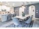Open concept dining area with marble table, gray chairs, and view of the kitchen at 2861 Monaghan Dr, Ormond Beach, FL 32174
