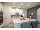 Modern kitchen with white cabinets, stainless steel appliances, and a spacious island with seating at 2861 Monaghan Dr, Ormond Beach, FL 32174