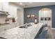Spacious kitchen island with stone countertop and dual sink; white cabinets and modern fixtures at 2861 Monaghan Dr, Ormond Beach, FL 32174