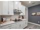 Kitchen featuring white cabinets, stainless steel hood, and cooktop on stone countertops at 2861 Monaghan Dr, Ormond Beach, FL 32174
