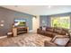 Living area with sectional sofa, TV, and wooden media center at 2861 Monaghan Dr, Ormond Beach, FL 32174