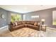 Living room featuring a plush sectional sofa, area rug, and large windows for natural light at 2861 Monaghan Dr, Ormond Beach, FL 32174