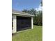 View of screened in lanai with dark screening and ample green lawn at 2861 Monaghan Dr, Ormond Beach, FL 32174