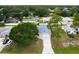 Aerial view of a charming home featuring a long driveway and mature trees in a quiet neighborhood at 2910 Yule Tree Dr, Edgewater, FL 32141