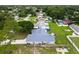 Aerial view of a single Gathering home in a residential neighborhood with mature trees at 2910 Yule Tree Dr, Edgewater, FL 32141