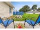 Cozy backyard patio area featuring a fire pit, blue chairs, and a blue fence at 2910 Yule Tree Dr, Edgewater, FL 32141