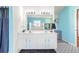 Charming bathroom features patterned floors and a dual sink vanity at 2910 Yule Tree Dr, Edgewater, FL 32141