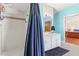 Stylish bathroom featuring a shower and vanity, complemented by modern blue walls at 2910 Yule Tree Dr, Edgewater, FL 32141