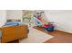Cozy bedroom features a wooden bed frame, hardwood floors, and indoor basketball game at 2910 Yule Tree Dr, Edgewater, FL 32141