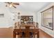 Dining room area featuring hardwood floors, a wooden table and chairs, and a built-in bookcase for storage at 2910 Yule Tree Dr, Edgewater, FL 32141